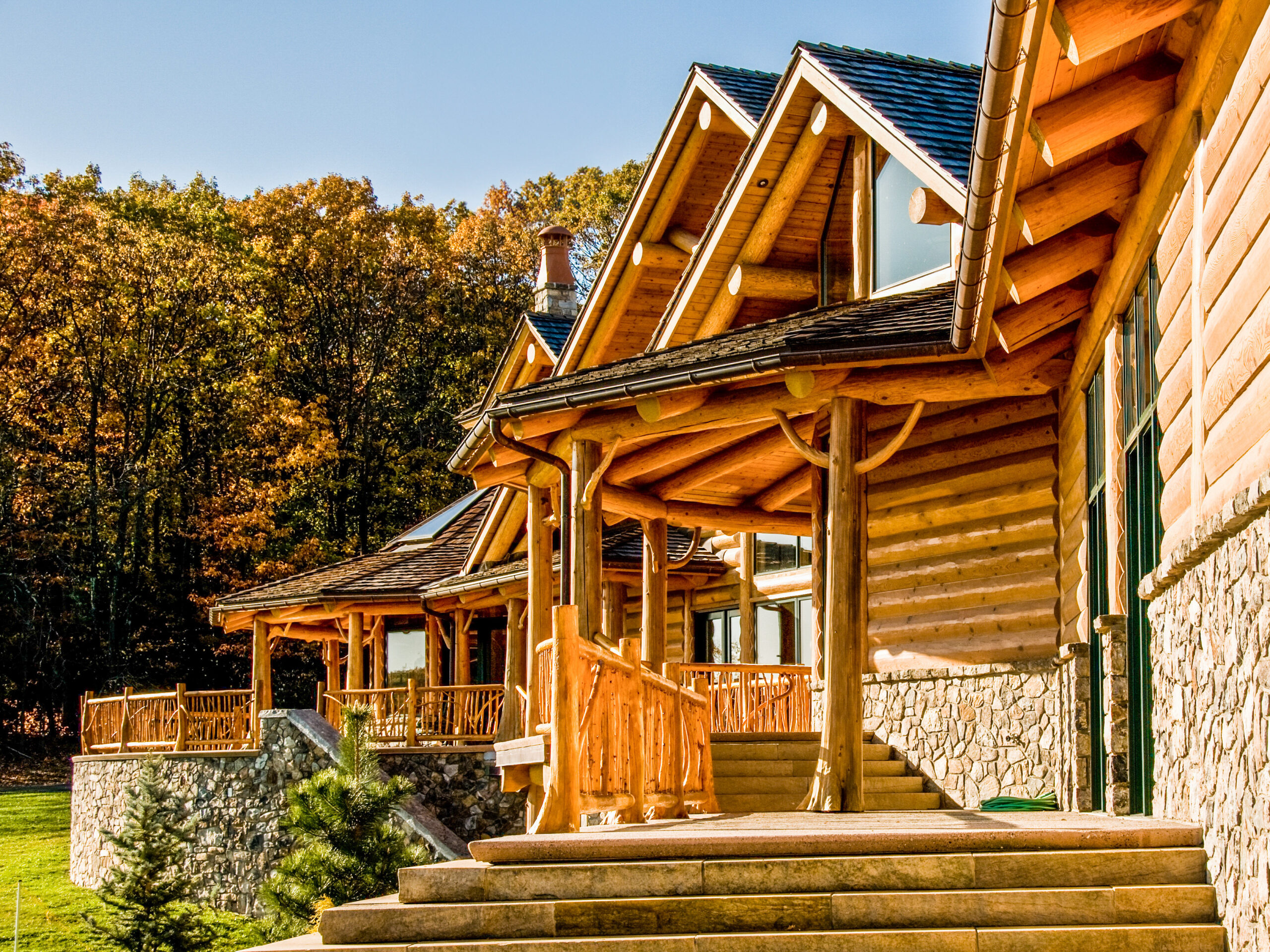 Exterior craftsmanship showing the home's log walls, covered decks and natural stone base