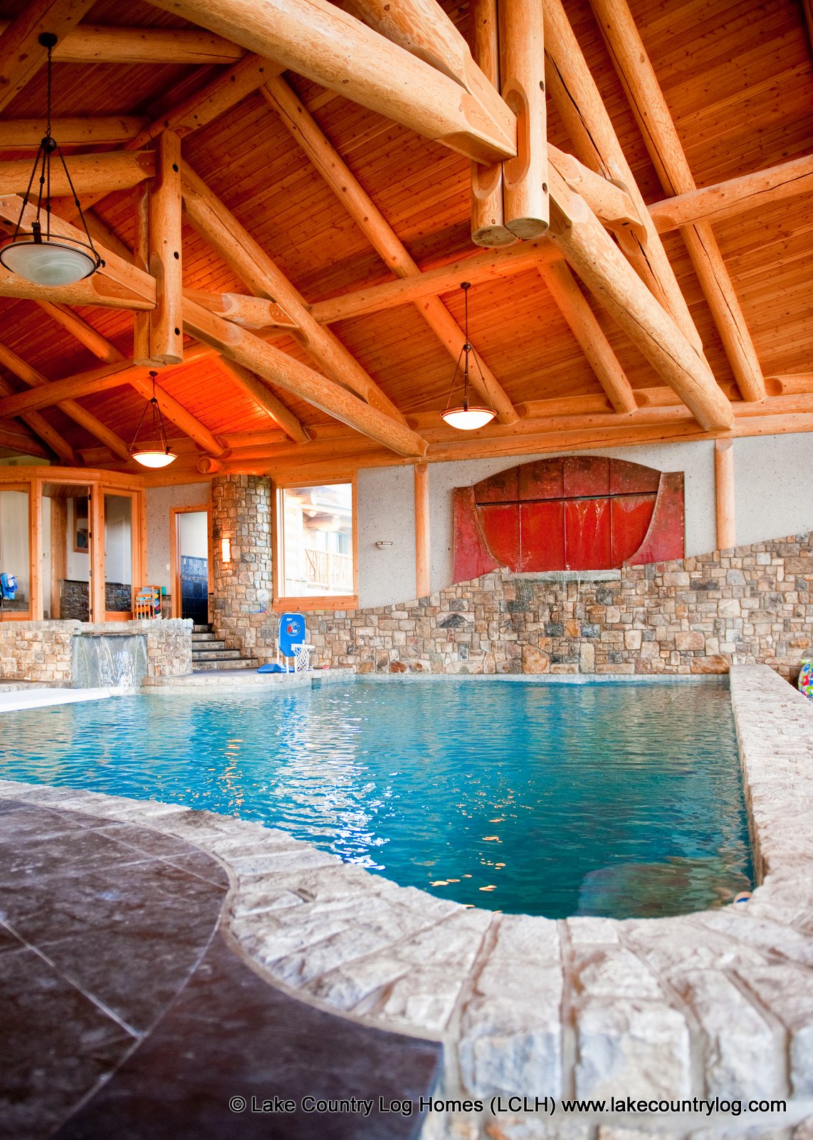 The expansive indoor pool beneath handcrafted Douglas Fir trusses and a wall of windows