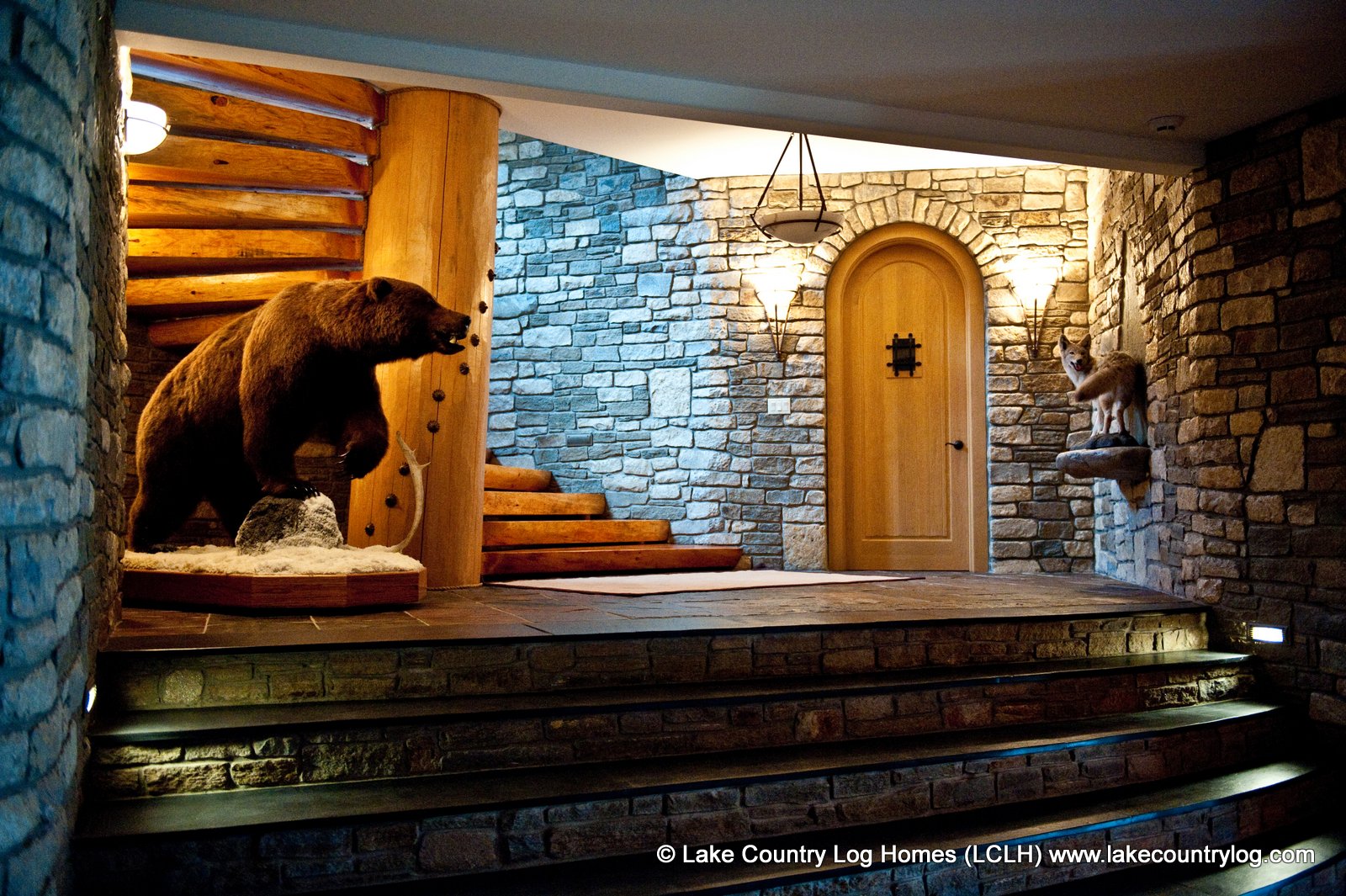 Natural stone stairs and a wildlife display at the base of the main staircase